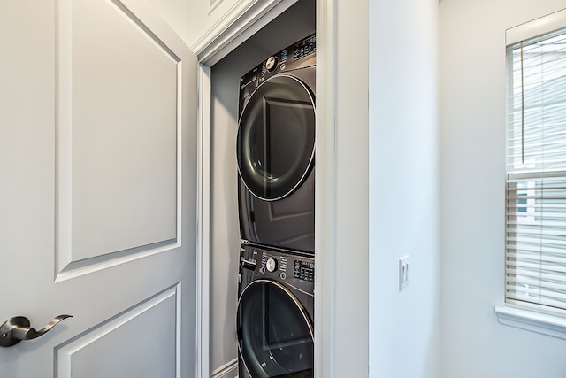 587 Anne Ave, Brighton, MI 48116 - clothes washing area featuring stacked washer / dryer, laundry area, and plenty of natural light