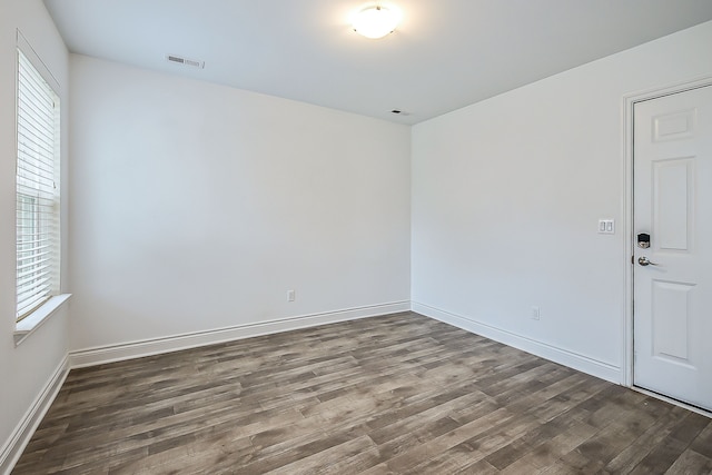 587 Anne Ave, Brighton, MI 48116 - spare room with a healthy amount of sunlight, baseboards, visible vents, and wood finished floors