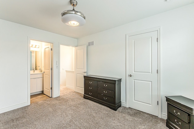 587 Anne Ave, Brighton, MI 48116 - unfurnished bedroom with ensuite bathroom, visible vents, baseboards, and carpet floors