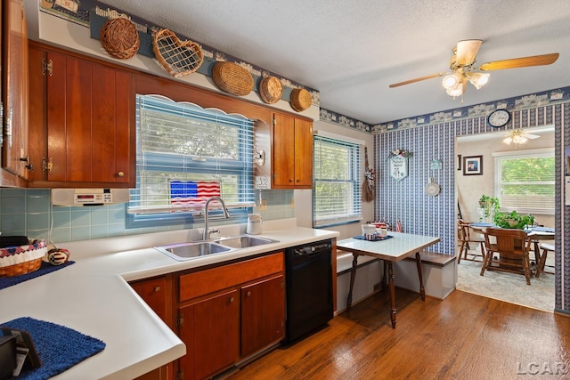 1402 Westhaven Blvd, Tecumseh, MI 49286 - kitchen featuring dishwasher, a sink, wallpapered walls, wood finished floors, and plenty of natural light