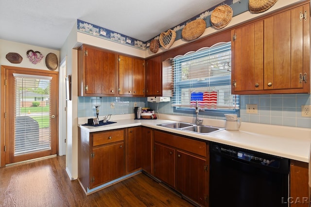 1402 Westhaven Blvd, Tecumseh, MI 49286 - kitchen featuring black dishwasher, a sink, dark wood-style flooring, and light countertops