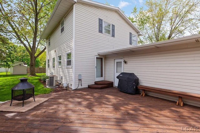 1402 Westhaven Blvd, Tecumseh, MI 49286 - wooden terrace featuring a shed, grilling area, an outbuilding, central AC, and a yard