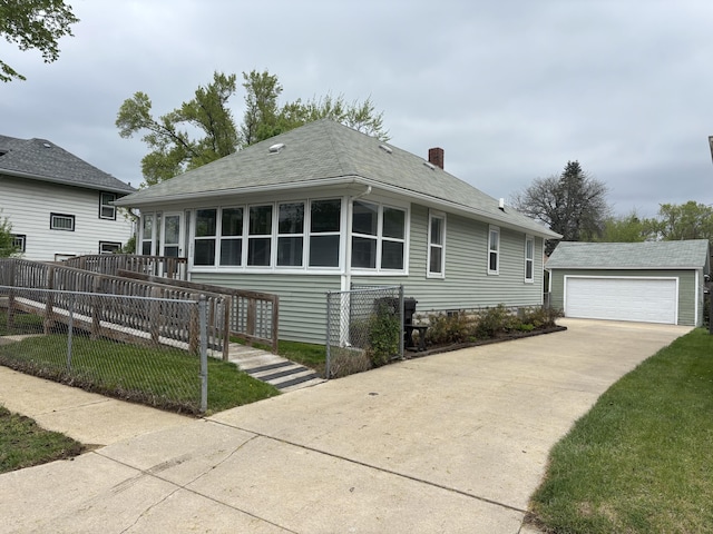 bungalow with a chimney, fence, an outdoor structure, a detached garage, and a shingled roof