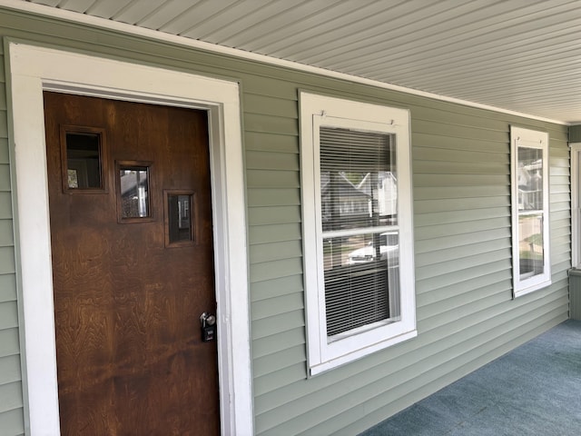 view of exterior entry with covered porch