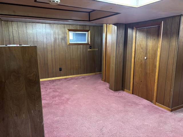 finished basement with carpet flooring and wood walls