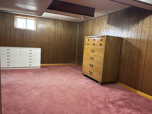 interior space featuring carpet flooring and wood walls