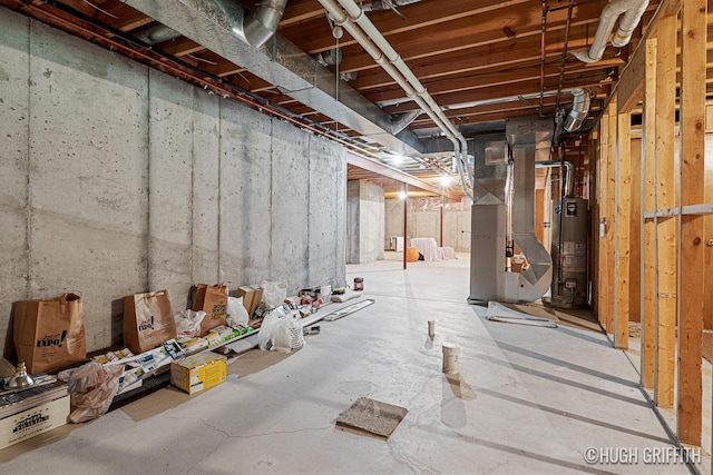 unfinished below grade area with heating unit and gas water heater