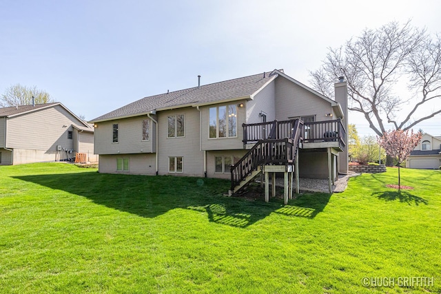 rear view of property featuring stairway, a wooden deck, and a lawn
