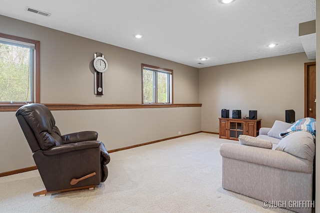 living room with carpet floors, baseboards, visible vents, and recessed lighting
