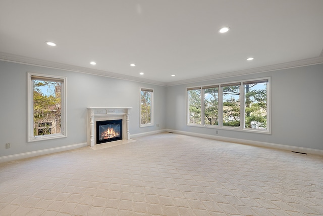 unfurnished living room with baseboards, recessed lighting, crown molding, and light colored carpet