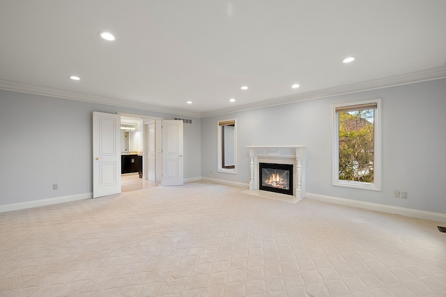 unfurnished living room with ornamental molding, a high end fireplace, and recessed lighting
