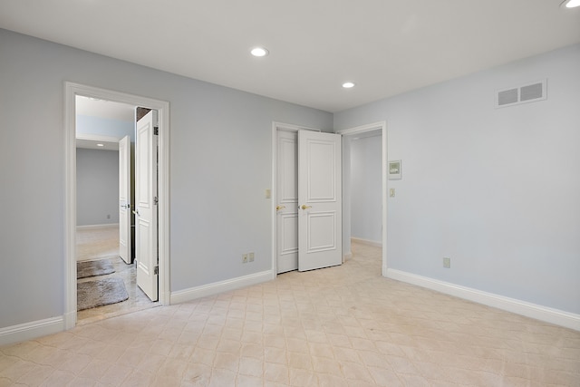 unfurnished bedroom with baseboards, visible vents, and recessed lighting