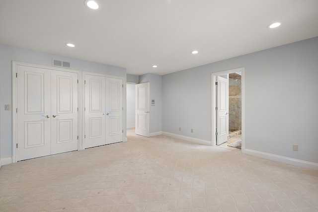 unfurnished bedroom featuring visible vents, baseboards, multiple closets, and recessed lighting
