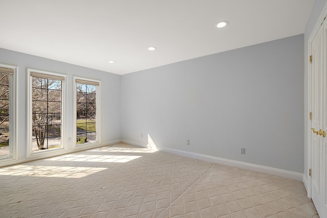 spare room featuring baseboards, recessed lighting, and light colored carpet