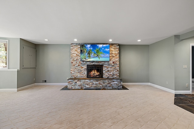 unfurnished living room featuring visible vents, baseboards, a stone fireplace, and recessed lighting
