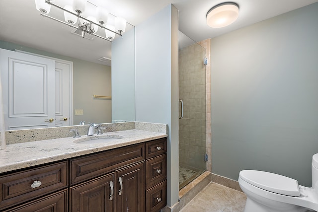 full bathroom featuring toilet, tile patterned floors, vanity, and a stall shower