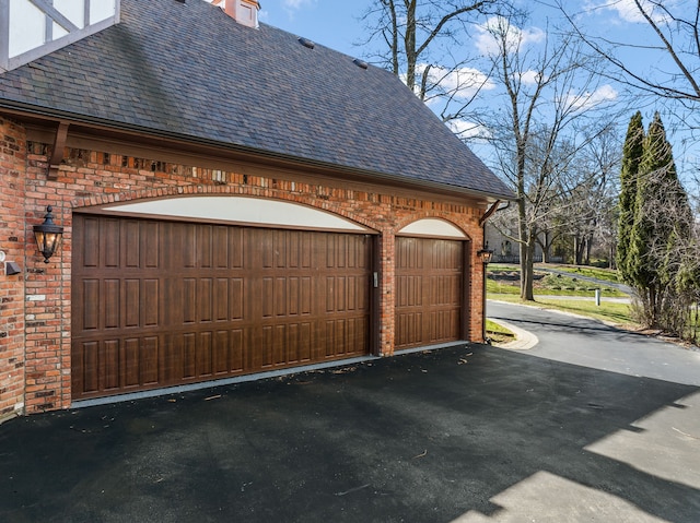 garage with aphalt driveway