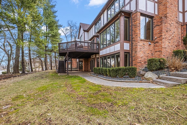 back of property with stairway, a wooden deck, and a yard