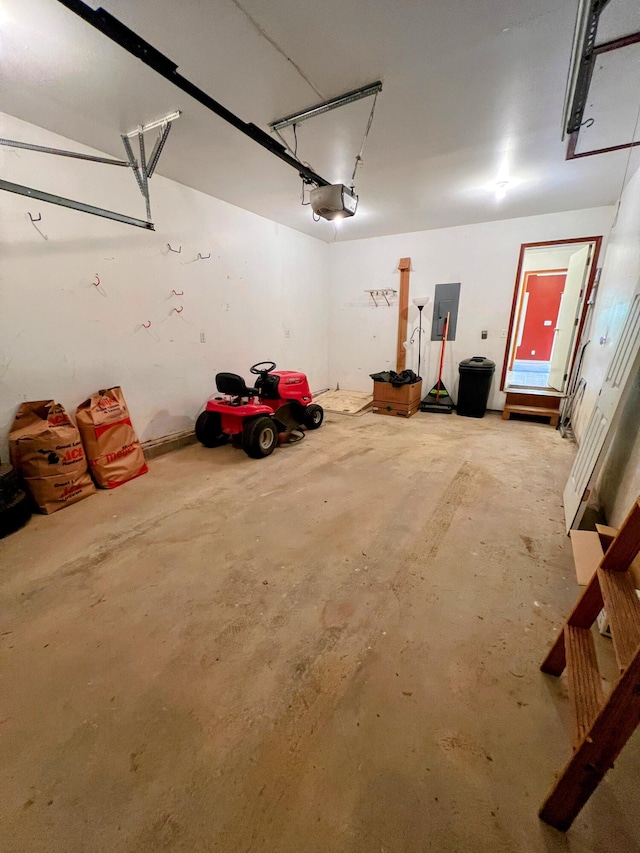 garage featuring electric panel and a garage door opener