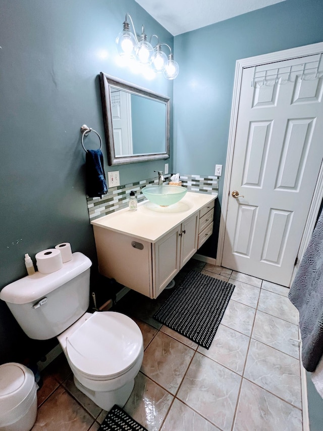 bathroom featuring tasteful backsplash, toilet, tile patterned flooring, and vanity