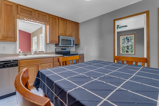 12938 Kelley Rd, Brooklyn, MI 49230 - kitchen featuring stainless steel appliances, a sink, tile counters, ceiling fan, and light tile patterned floors