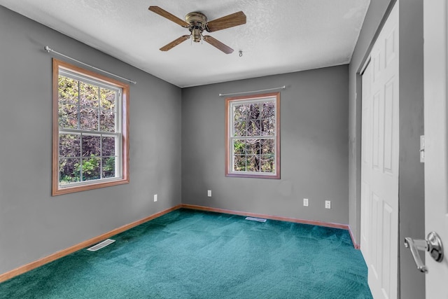 12938 Kelley Rd, Brooklyn, MI 49230 - unfurnished bedroom featuring carpet, baseboards, a textured ceiling, ceiling fan, and a closet