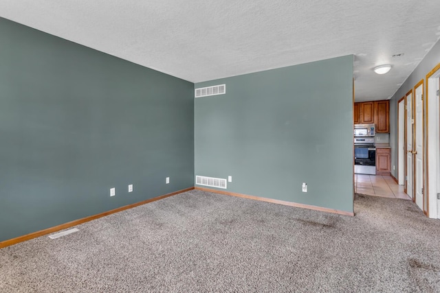 12938 Kelley Rd, Brooklyn, MI 49230 - empty room featuring light carpet, baseboards, and a textured ceiling