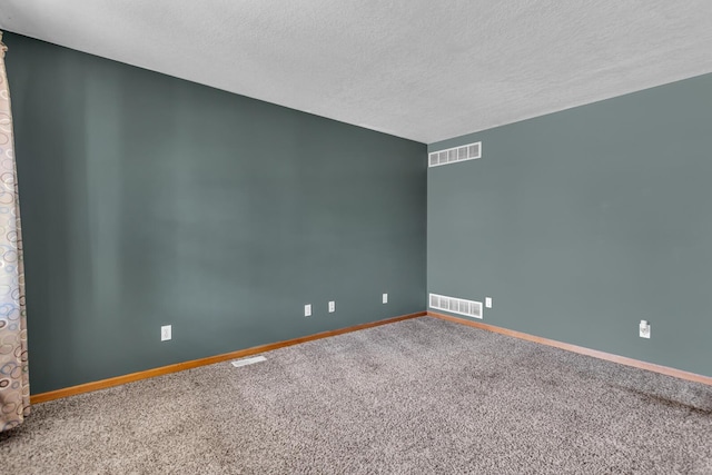 12938 Kelley Rd, Brooklyn, MI 49230 - empty room featuring a textured ceiling, carpet floors, and baseboards