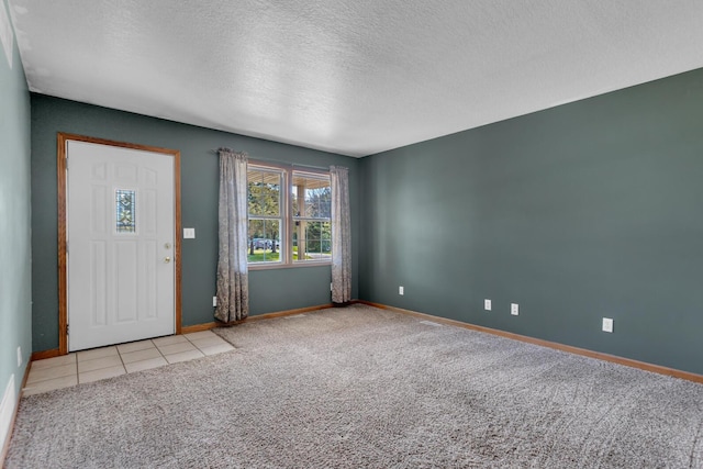 12938 Kelley Rd, Brooklyn, MI 49230 - entrance foyer with baseboards, a textured ceiling, carpet flooring, and tile patterned flooring