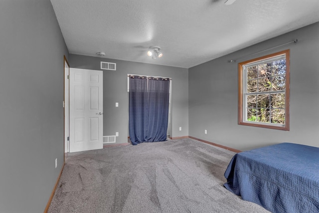 12938 Kelley Rd, Brooklyn, MI 49230 - carpeted bedroom featuring baseboards and a textured ceiling