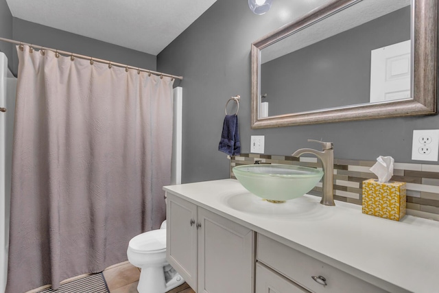 12938 Kelley Rd, Brooklyn, MI 49230 - full bathroom featuring backsplash, vanity, toilet, a shower with shower curtain, and tile patterned flooring