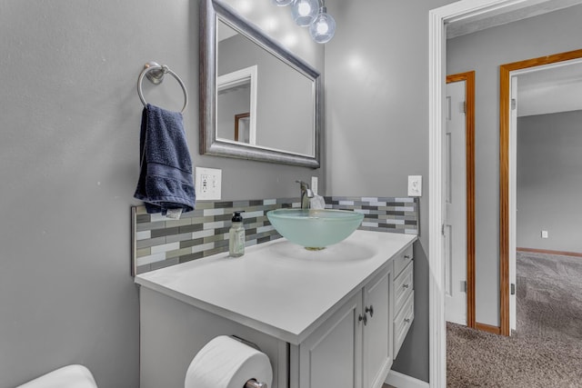 12938 Kelley Rd, Brooklyn, MI 49230 - bathroom featuring decorative backsplash, vanity, and baseboards