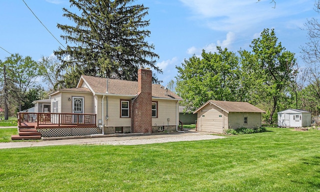 view of front of property featuring an outbuilding, a chimney, a wooden deck, a front lawn, and a storage shed