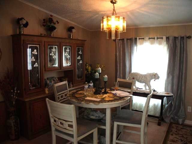 dining space featuring crown molding and a chandelier