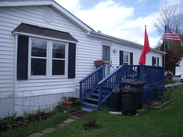 back of house with a lawn