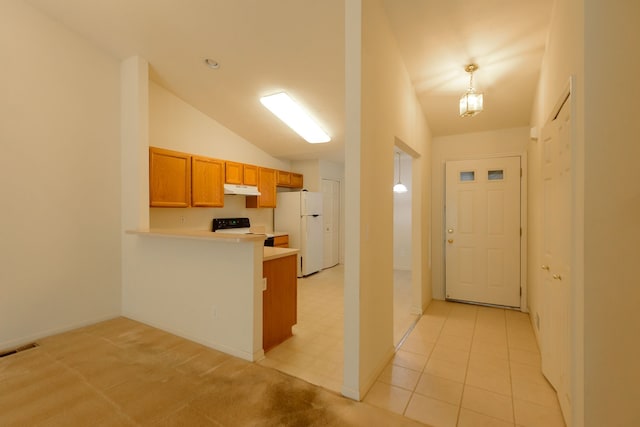 22876 Woodcreek Dr, Taylor, MI 48180 - kitchen featuring freestanding refrigerator, under cabinet range hood, range with electric cooktop, brown cabinetry, and a peninsula