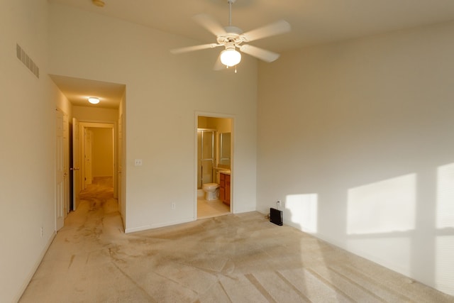 22876 Woodcreek Dr, Taylor, MI 48180 - spare room featuring light colored carpet, a ceiling fan, baseboards, and a towering ceiling