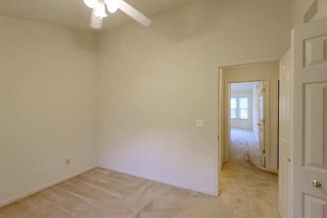 22876 Woodcreek Dr, Taylor, MI 48180 - empty room featuring light colored carpet, a ceiling fan, and baseboards