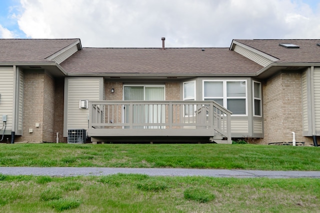 22876 Woodcreek Dr, Taylor, MI 48180 - back of house with a wooden deck, brick siding, a yard, and roof with shingles