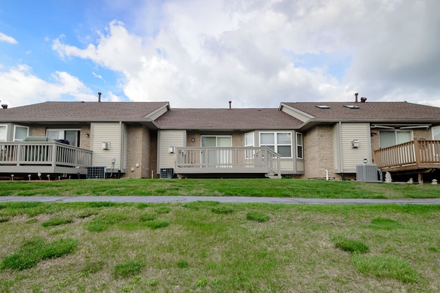 22876 Woodcreek Dr, Taylor, MI 48180 - rear view of property with brick siding, a deck, central air condition unit, and a yard
