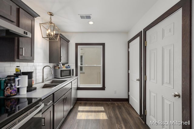 506 Fairview Ave NE, Grand Rapids, MI 49503 - kitchen featuring a sink, stainless steel appliances, a notable chandelier, and dark brown cabinets