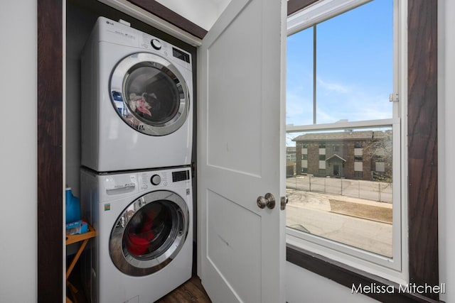 506 Fairview Ave NE, Grand Rapids, MI 49503 - laundry room featuring laundry area, stacked washing maching and dryer, and plenty of natural light
