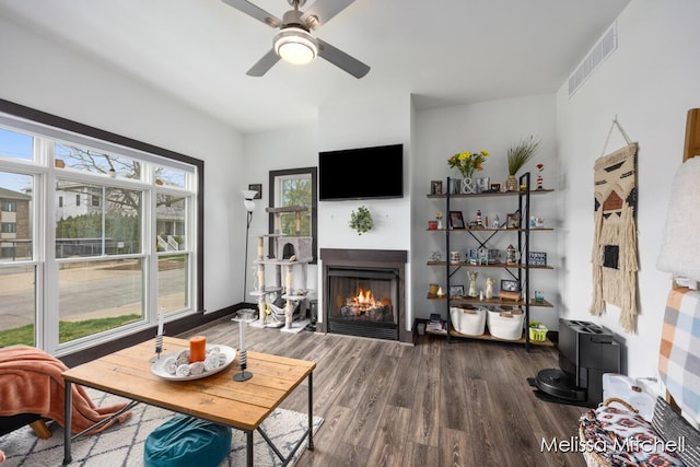 506 Fairview Ave NE, Grand Rapids, MI 49503 - living room with a lit fireplace, ceiling fan, visible vents, and wood finished floors