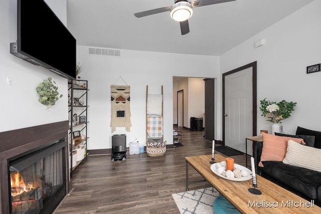 506 Fairview Ave NE, Grand Rapids, MI 49503 - living area featuring a warm lit fireplace, wood finished floors, visible vents, a ceiling fan, and baseboards