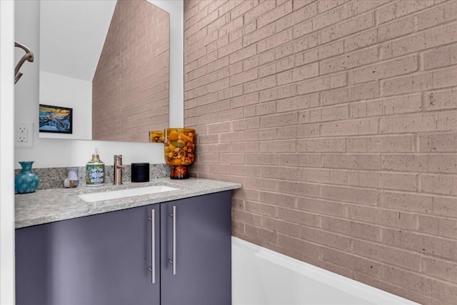 2809 Brush St, Detroit, MI 48201 - bathroom with brick wall, vanity, and a bathing tub
