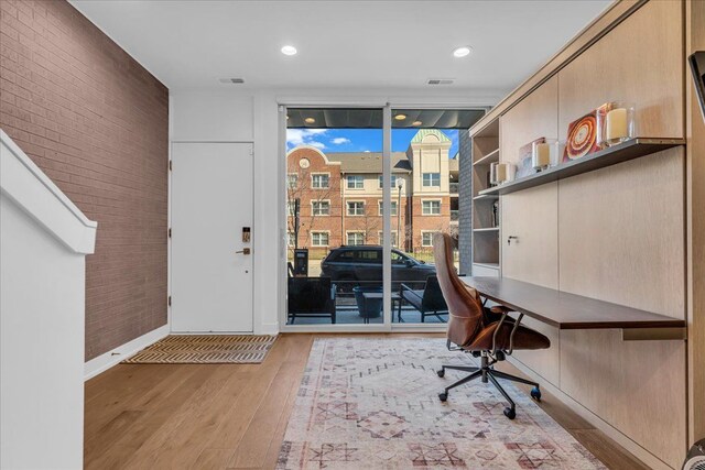 2809 Brush St, Detroit, MI 48201 - office featuring expansive windows, visible vents, baseboards, and light wood-type flooring