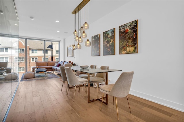 2809 Brush St, Detroit, MI 48201 - dining room featuring a wall of windows, baseboards, hardwood / wood-style floors, and recessed lighting