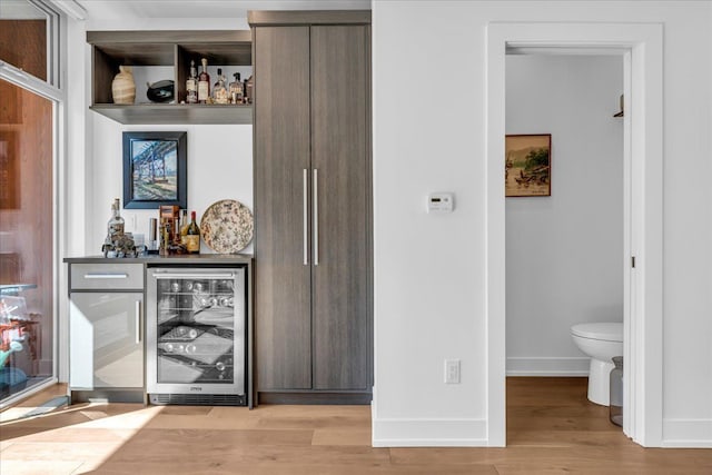 2809 Brush St, Detroit, MI 48201 - bar with wine cooler, baseboards, a dry bar, and light wood-style floors