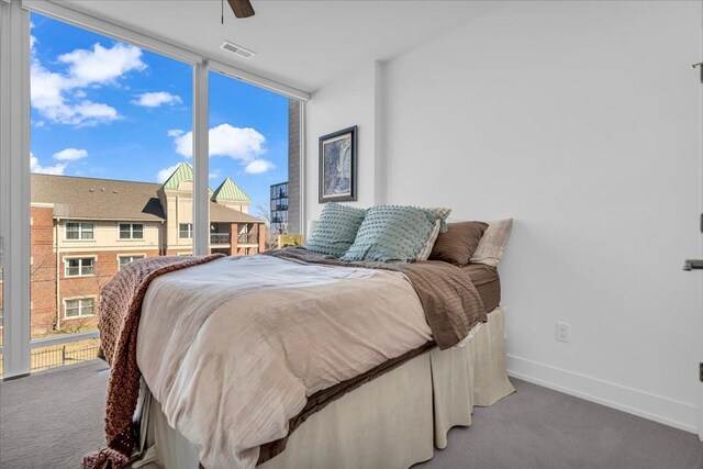 2809 Brush St, Detroit, MI 48201 - bedroom with baseboards, a wall of windows, a ceiling fan, and carpet floors