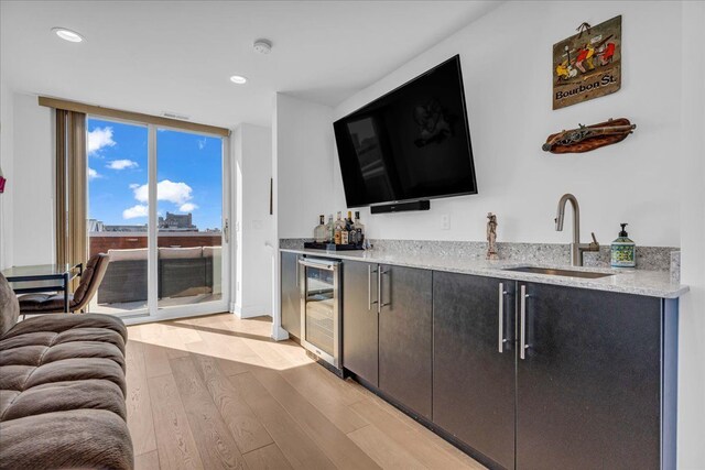 2809 Brush St, Detroit, MI 48201 - bar featuring a sink, wet bar, recessed lighting, light wood finished floors, and beverage cooler